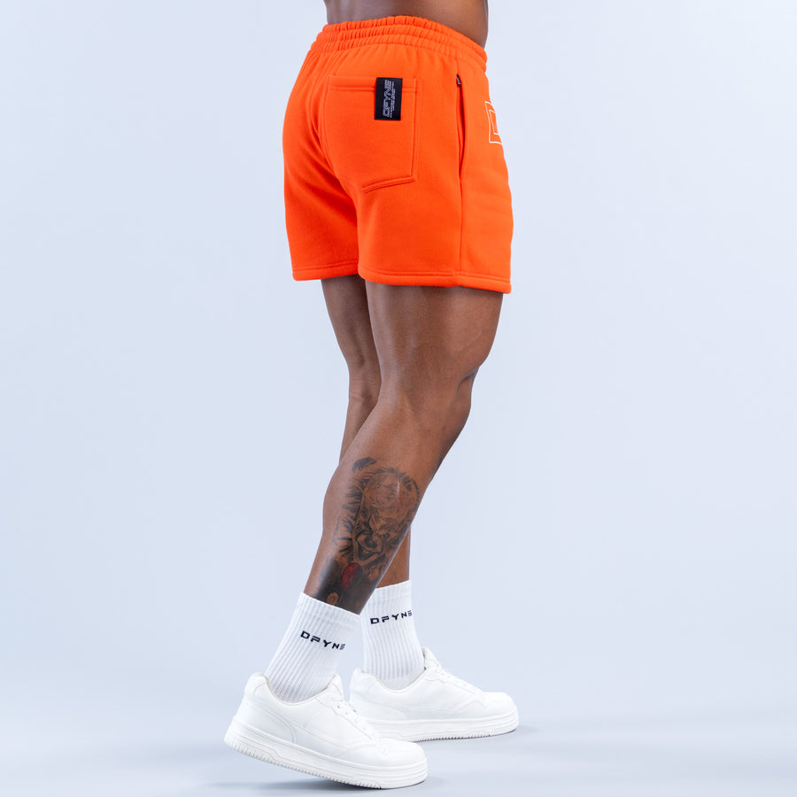 Orange jogger shorts, back view with pocket label and elastic waistband