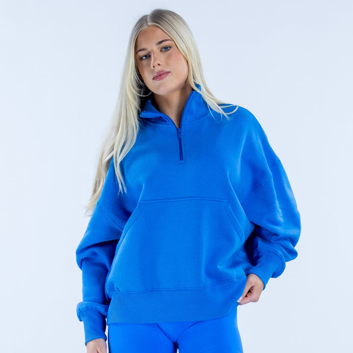 Blue quarter-zip sweatshirt with ribbed cuffs and kangaroo pocket, relaxed fit