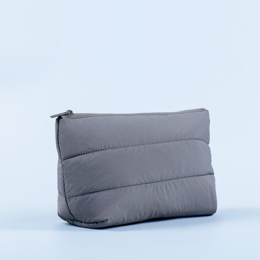 Padded zip pouch, dark gray, angled side view with visible zipper and seams