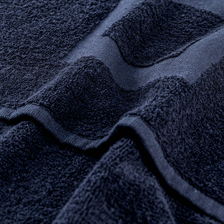 Navy gym towel close-up: textured loops and stitched edge