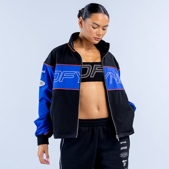 Kids track jacket, black and blue with red trim, open front style and logo chest