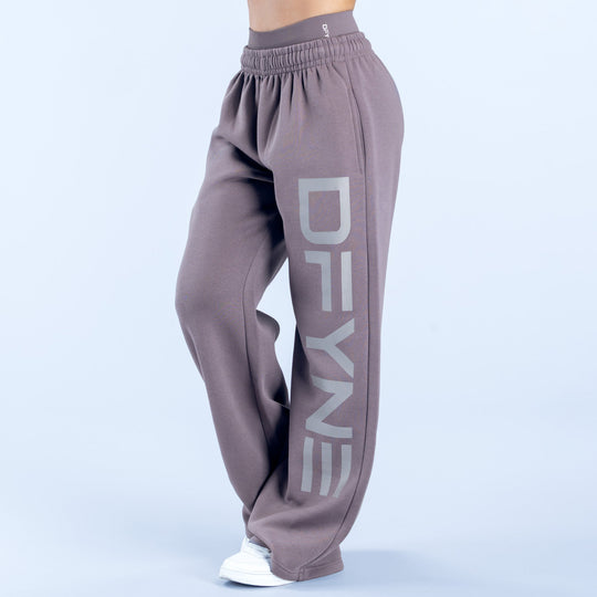 Taupe wide-leg joggers with elastic waist and large 'DENY' side graphic