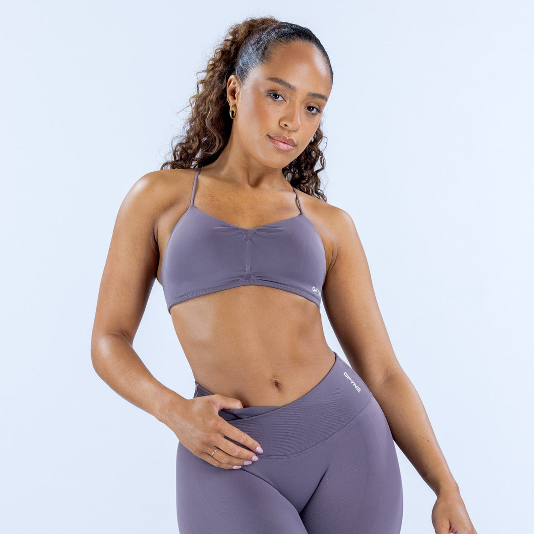 Women's seamless sports bra in lavender with thin straps and front crossover seam