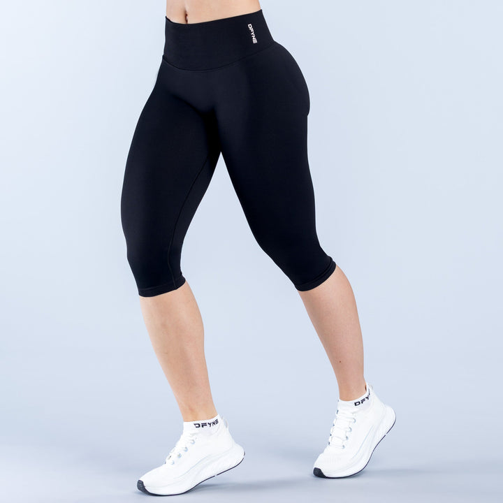 Black straight-waistband capri leggings, 3/4 length with slim fitted legs.