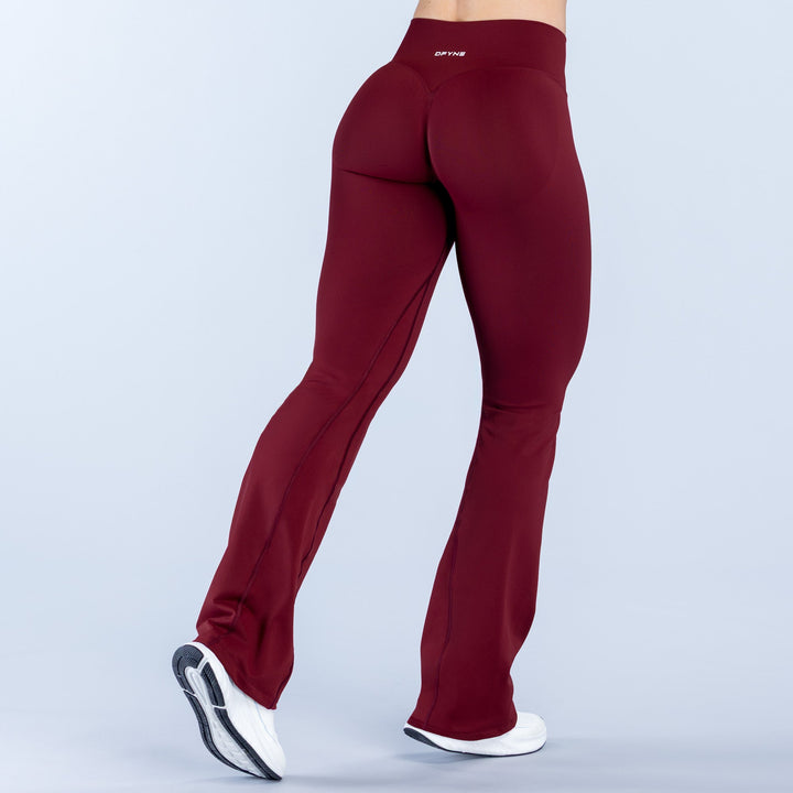Burgundy straight-waistband flare leggings, back view, contoured seams